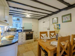 a kitchen and dining room with a table and chairs at 2 Bed in Hawkshead Village LLH35 in Hawkshead +10 photos