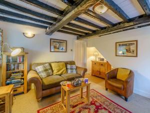 a living room with a couch and a table and chairs at 2 Bed in Hawkshead Village LLH35 in Hawkshead