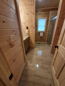 a wooden bathroom with a sink and a door at Misty Mountain View - 2 bedroom cabin in Glade