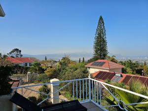 a view from a balcony of a house with a tree at Somerset Hill in Somerset West