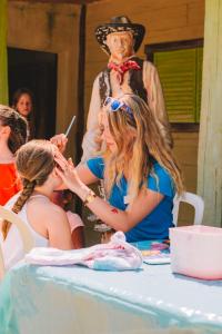 a woman cutting a girls hair in front of a table at Mobile Homes by KelAir at Camping Les Genets in Saint-Jean-de-Monts +80 photos