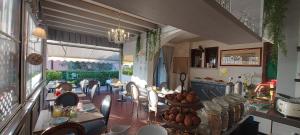 a dining room with a table and chairs and a dining room at Florence Garda Hotel in Manerba del Garda