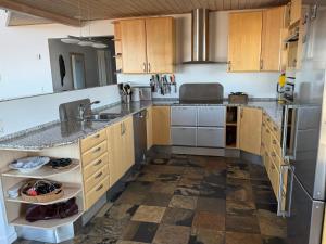 a kitchen with wooden cabinets and a sink at Byens bedste udsigt in Nuuk