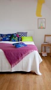 a bedroom with a bed with a purple blanket at Haus am Meer in Koserow in Ostseebad Koserow