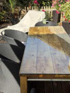 a wooden table with two chairs around it at Haus am Meer in Koserow in Ostseebad Koserow