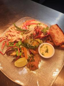 a plate of food with shrimp and vegetables on a table at Pond Cottage in Covington +7 photos