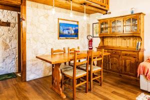a dining room with a wooden table and chairs at Casa vacanza Campotosto in Campotosto