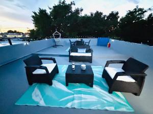 a patio with couches and a table on a roof at Levi Beach in Toa Baja