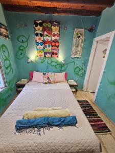a bedroom with a large bed in a room with blue walls at LaLaLand in Mikonos