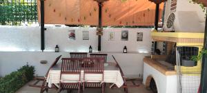 a patio with a table and two chairs at Natageo in Loutraki