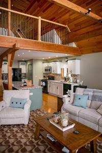 a living room with two couches and a kitchen at The Lodge on Lamoka in Bradford