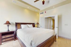 Un dormitorio con una cama grande y un ventilador de techo. en Lahaina Shores 125, en Lahaina 22 fotos más