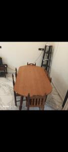 a wooden table in a room with a ladder at Nagesh paikera biligeri in Madikeri