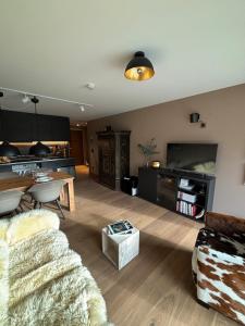 a living room with a couch and a table at AVO 2 room wellness apartment in Laax