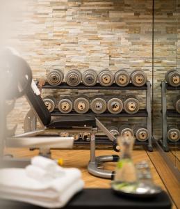 a desk with a lamp and a machine in a room at AVO 2 room wellness apartment in Laax +20 photos