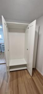 a white cabinet in a room with a wooden floor at Smartes Business Studio in Immensee