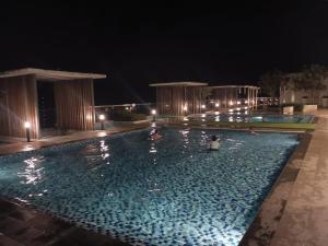a swimming pool at night with lights at Windmill Upon Hills Genting Highland by El Naura in Genting Highlands