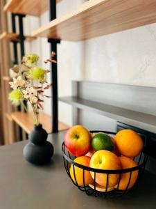 a bowl of fruit on a table with a vase at NEW Loft-style studio in Zhytomyr +5 photos