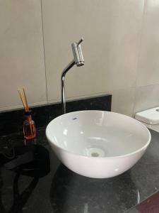 a white sink with a faucet in a bathroom at CF Flat 01 in Petrolina