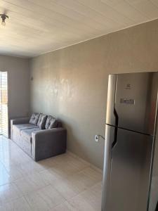 a living room with a couch and a refrigerator at Apartment rental for COP30 in Belém