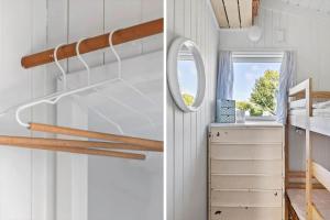 a bedroom with white walls and a mirror at 5700-Svaneke-Duebakken-9 in Svaneke