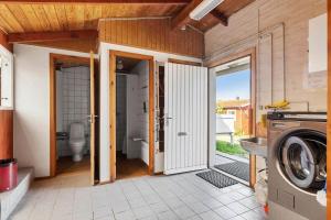 a bathroom with a washer and dryer in a house at 5700-Svaneke-Duebakken-9 in Svaneke
