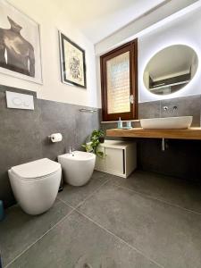 a bathroom with a toilet and a sink and a mirror at Villa Demirà - Chic Panoramic Rooms Marsala in Marsala +55 photos