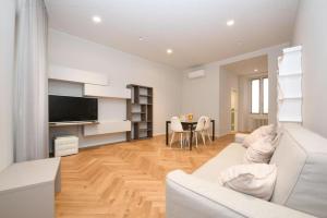 a living room with a white couch and a table at Living Salò in Salò