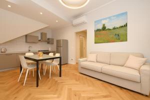 a living room with a white couch and a table at Living Salò in Salò