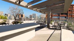 a patio with tables and chairs on a building at White 2880 - Pinheiros in Sao Paulo
