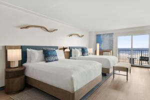 a hotel room with two beds and a balcony at The Seahaus Hotel, Atlantic City Boardwalk, a Tribute Portfolio Hotel in Atlantic City +63 photos