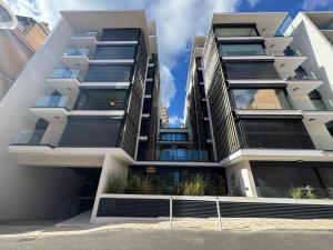 an apartment building with balconies on a street at Stylish 2BR Monaco Border Flat, Terrace & Parking in Beausoleil