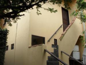 a stairway leading up to a building with a door at Estalagem Tatu&iacute; in Cabo Frio
