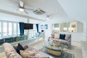 a living room with a couch and a table at Baan Hua Hin 4 Bedroom Luxury Villa by the Ocean in Hua Hin