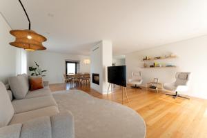 a living room with a couch and a tv at Casa do Avô in Viana do Castelo