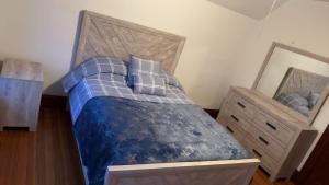 a bedroom with a bed with a wooden headboard and a mirror at My Kingdom in Everett