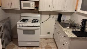 a kitchen with a white stove and a sink at My Kingdom in Everett