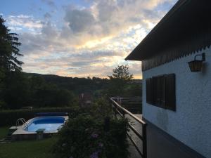 a view of a house and a swimming pool at Family House with Pool in Kamenny Privoz, 30 km from Prague, in beautiful nature in Kamenný Přívoz