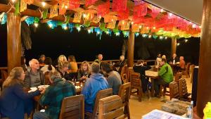 a group of people sitting at tables in a restaurant at Azul Beach Kite Resort in El Sargento +113 photos