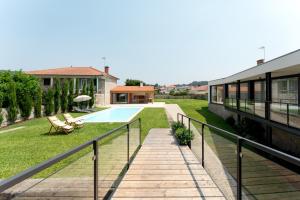 an external view of a house with a swimming pool at Casa do Avô in Viana do Castelo