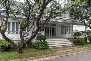 a white house with trees in front of it at Baan Hua Hin 4 Bedroom Luxury Villa by the Ocean in Hua Hin