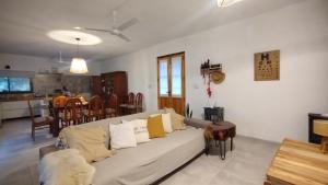 a living room with a couch and a kitchen at Sol & Río Refugio Serrano in Villa Las Rosas +13 photos