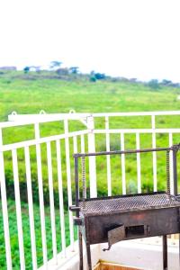 a wooden bench sitting next to a white fence at AregeHomes in Nakuru