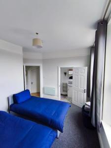 a bedroom with two blue beds in a room at Dover Heights in Dover +12 photos