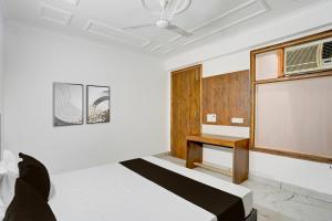 a room with a bed and a table in it at Hotel O Dk Hotel in Okhla