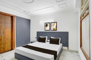 a bedroom with a large bed in a room at Hotel O Dk Hotel in Okhla