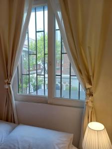 a bedroom with a window with a bed and a lamp at 어반 팀버 수원 in Hagwanggyo-dong