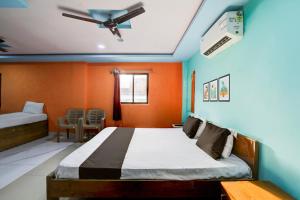 Katil atau katil-katil dalam bilik di Hotel O Maa Ganga's