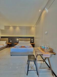 a bedroom with a bed and a table and a chair at Casa Casa in Semporna