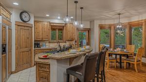 a kitchen with a table and a clock on the wall at The Breck Haus in Breckenridge +31 photos